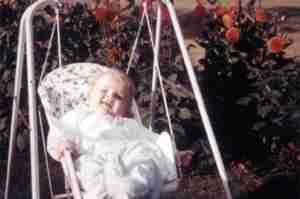 Toby Simkin as newborn baby in swing